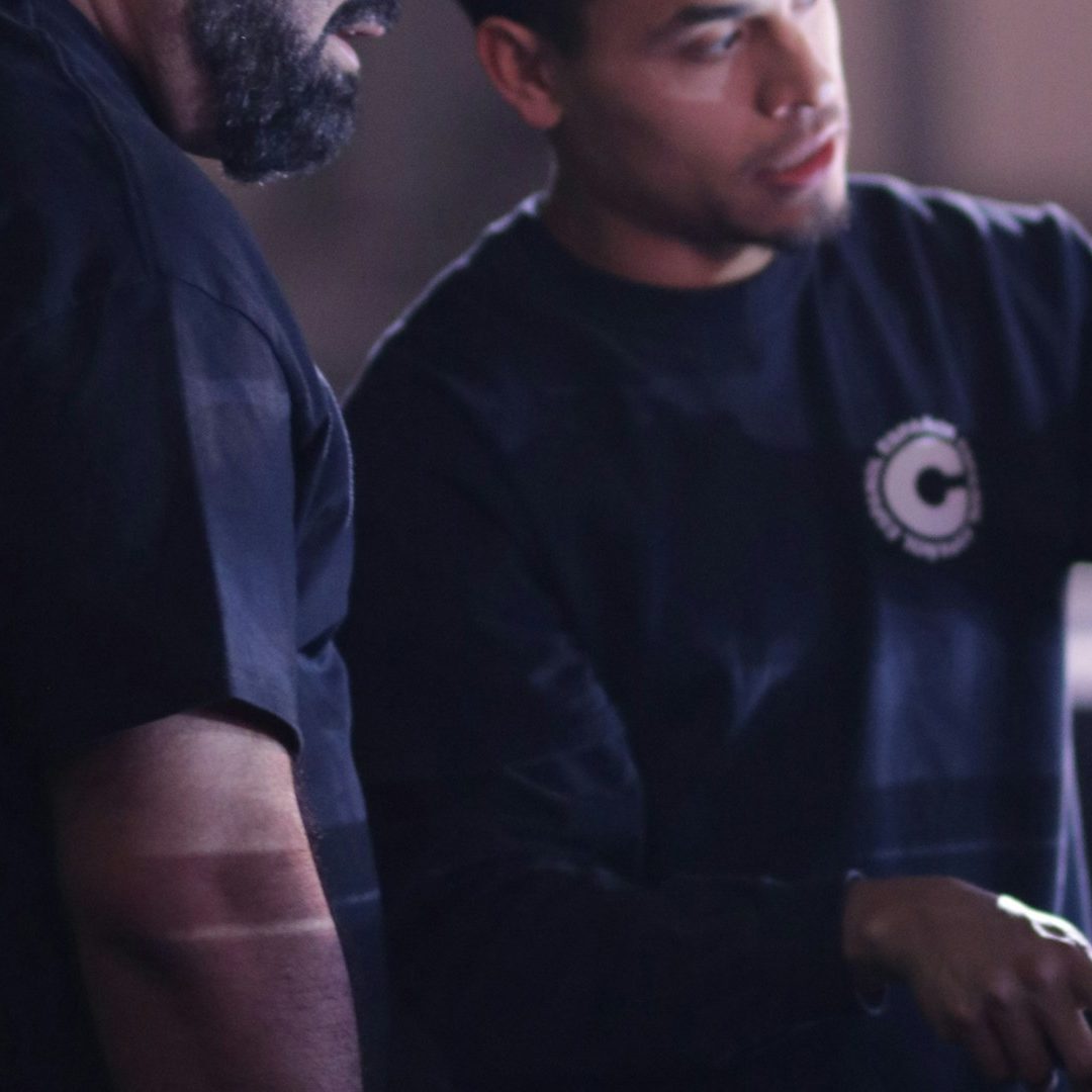 Two men collaborating on a task, focused and engaged in discussion.