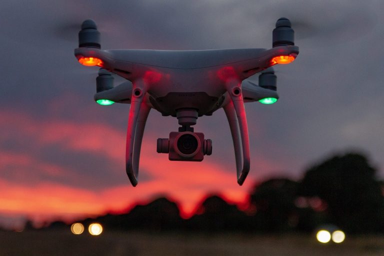 Artificial Intelligence Drone equipped with a camera against a sunset sky.
