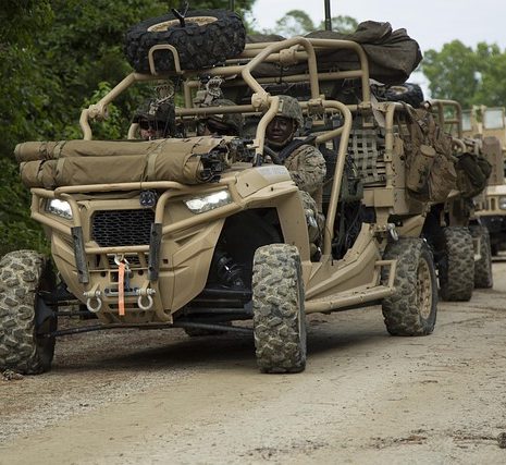 Military all-terrain vehicle equipped for rugged terrain and combat situations.